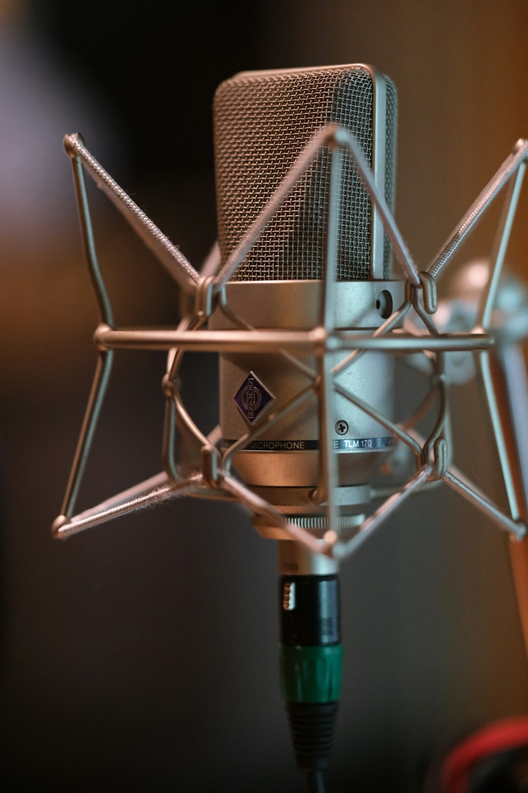 Home recording studio with mixing desk, acoustic panels and vintage microphone
